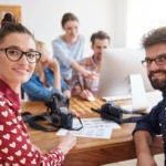 coworkers office with photo cameras computer