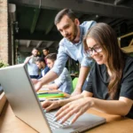 picture beautiful lady glasses listening her partner ot colleague businesswoman working laptop computer restaurant cafe