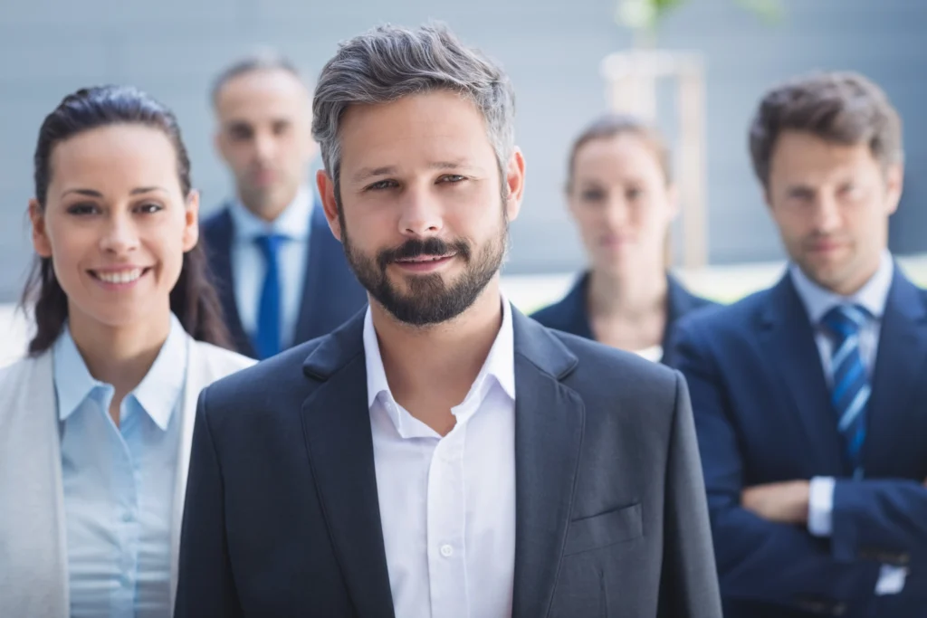 confident businessman with colleagues